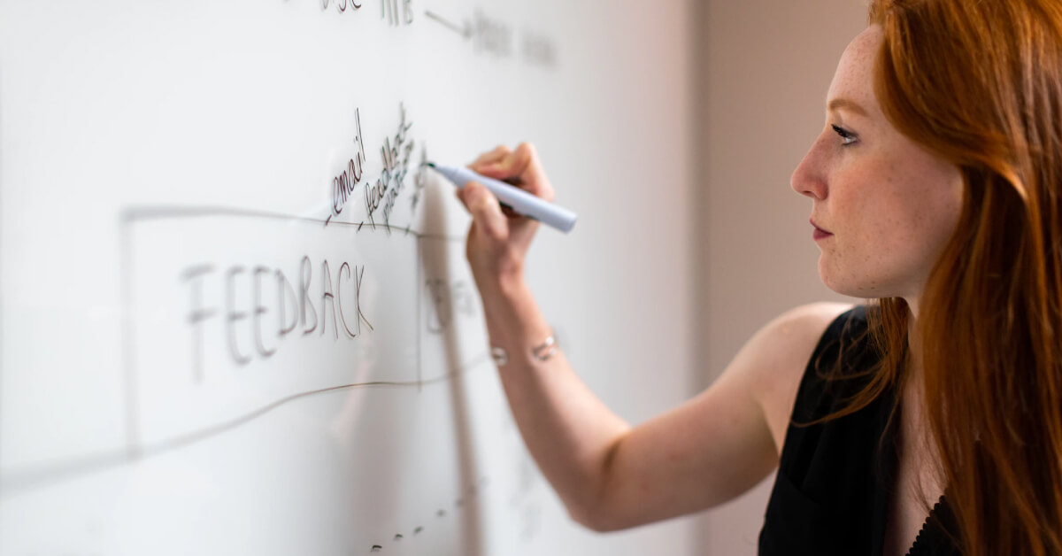 pabliq-woman-writing-on-whiteboard